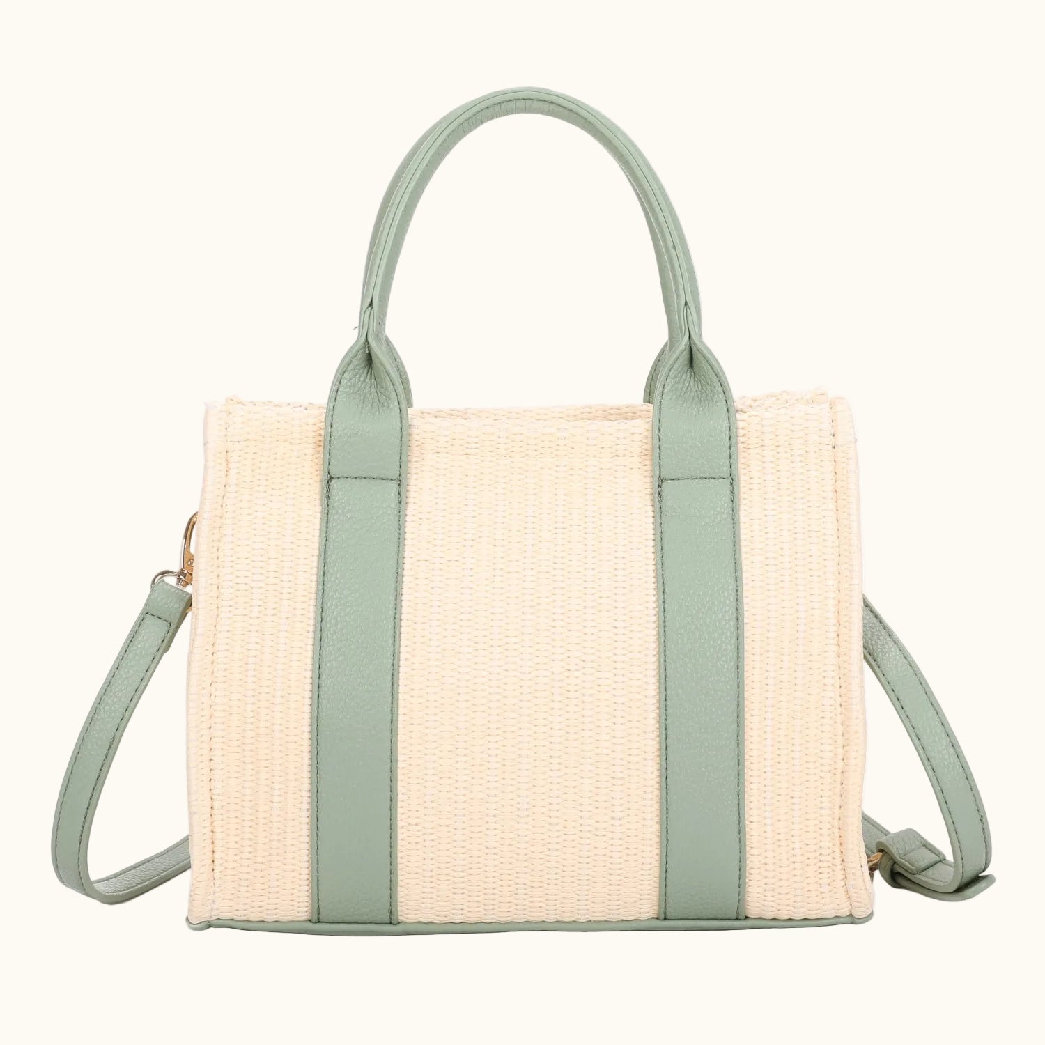 Beige woven handbag with green straps on a white background