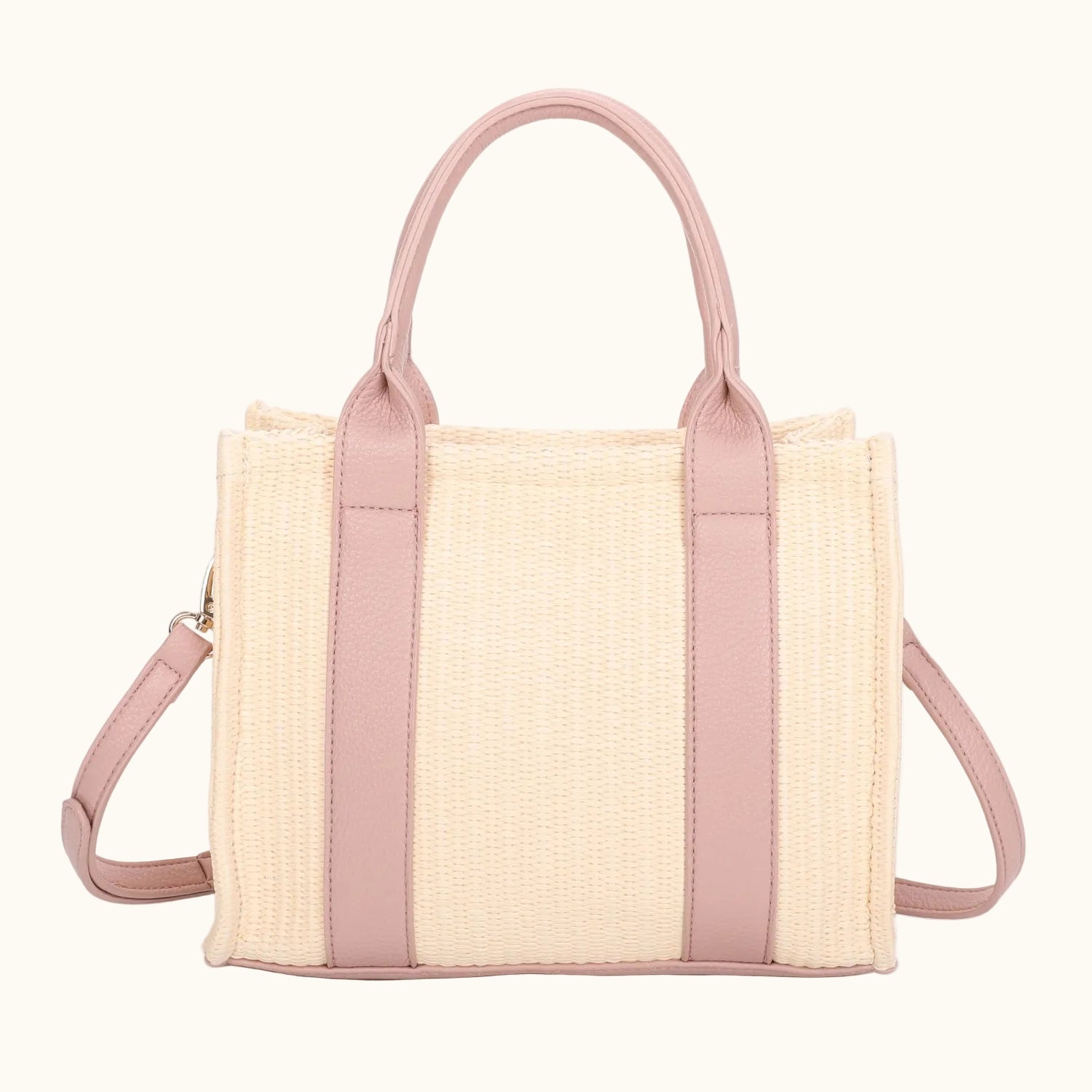 Woven handbag with pink accents on a white background