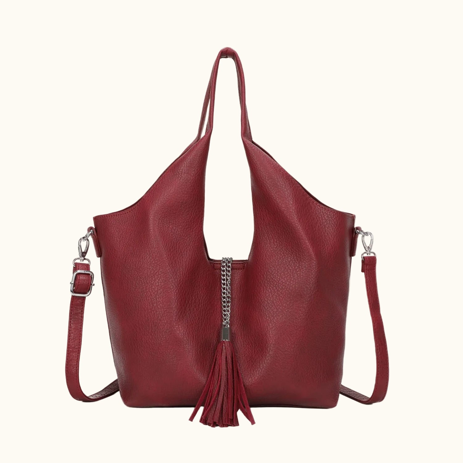 Red handbag with a chain detail and tassel on a white background