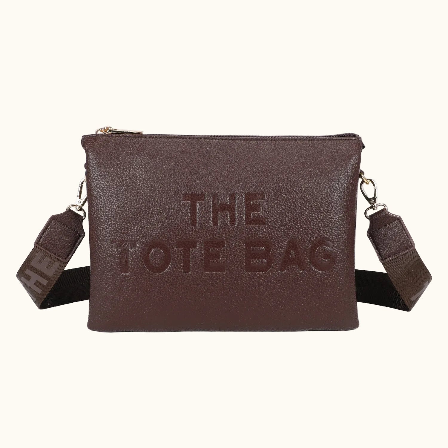 Brown tote bag with 'THE TOTE BAG' embossed on it, on a white background