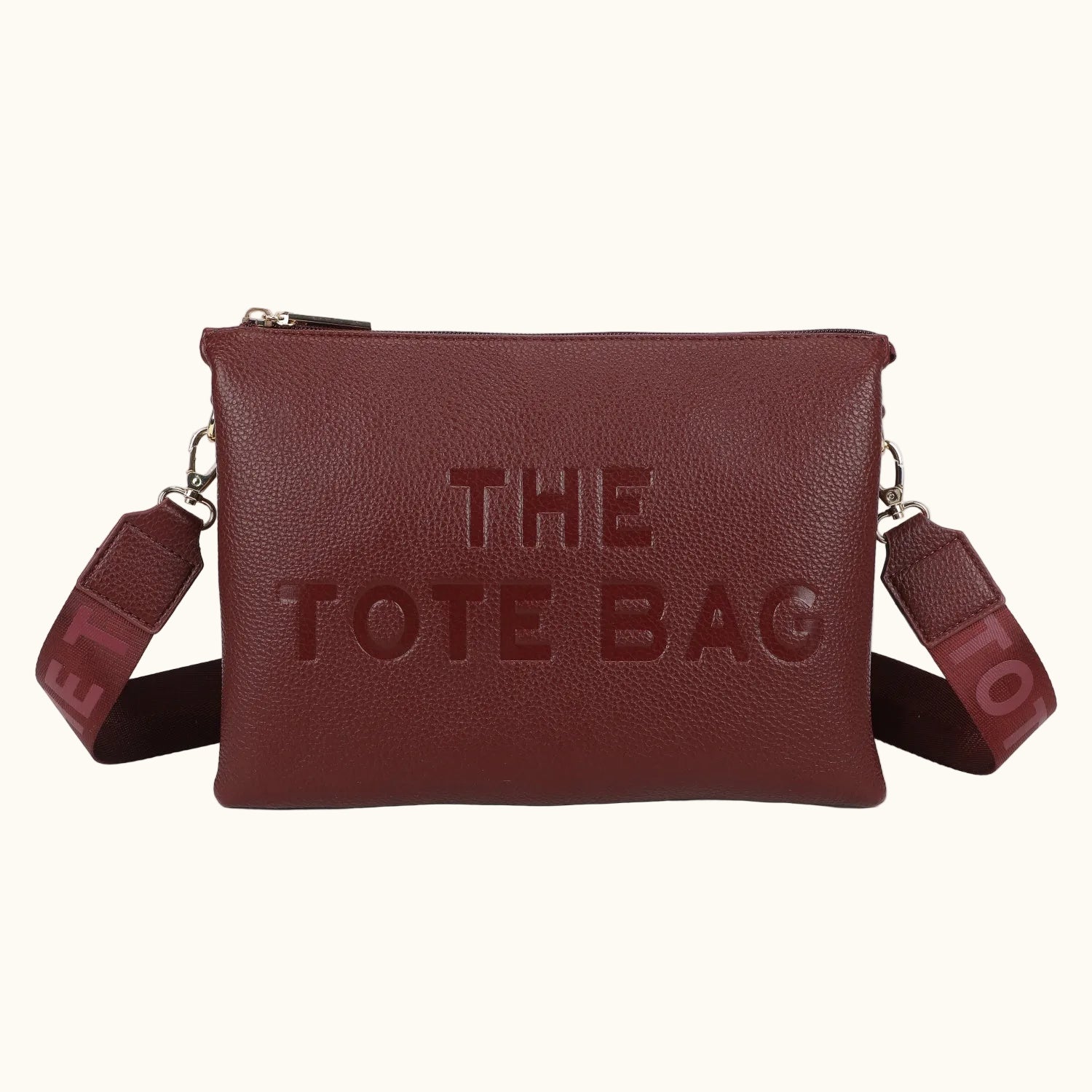 Brown leather tote bag with 'THE TOTE BAG' text on a white background