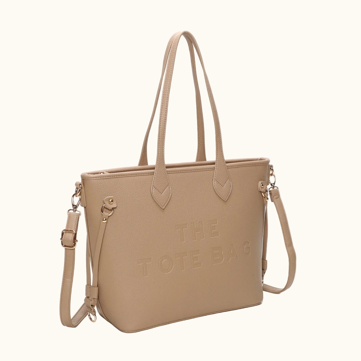 Beige tote bag with 'THE TOTE BAG' text on a white background