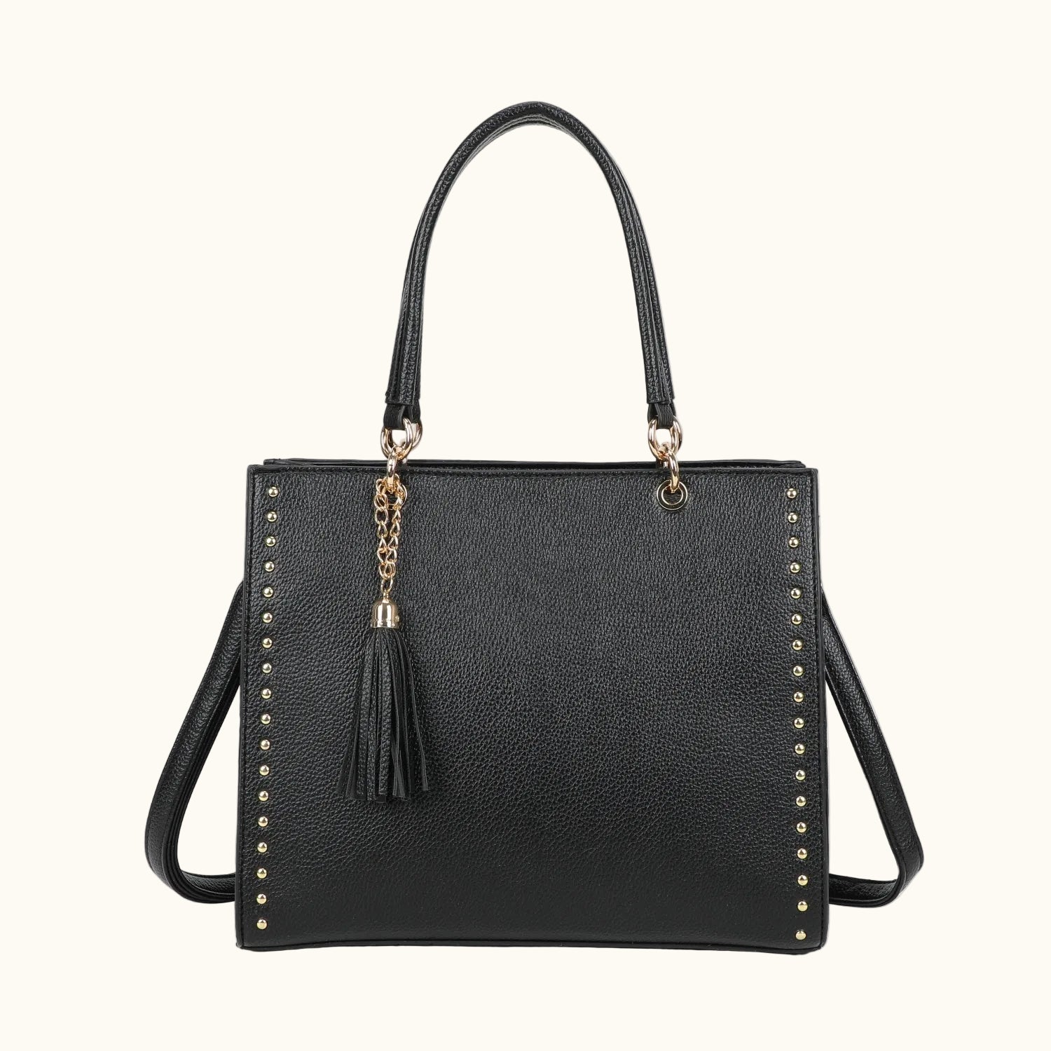 Black handbag with studded details and a tassel on a white background