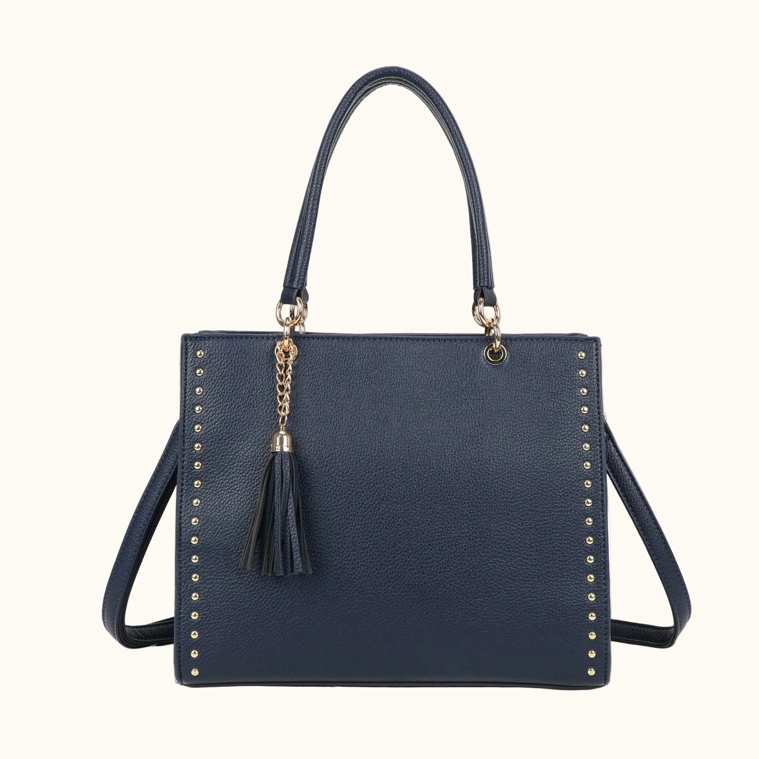 Navy blue handbag with gold accents and a tassel on a white background