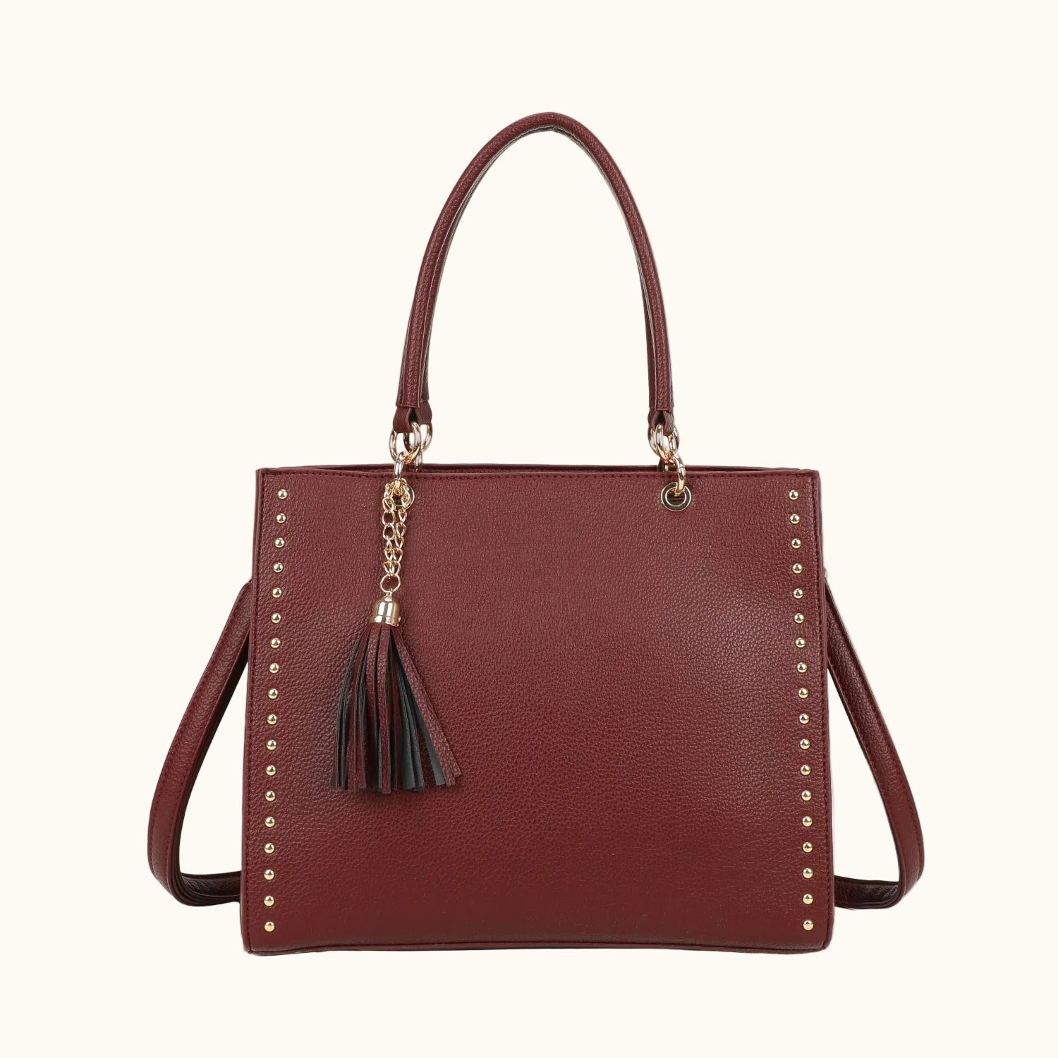 Brown handbag with studded details and a tassel on a white background