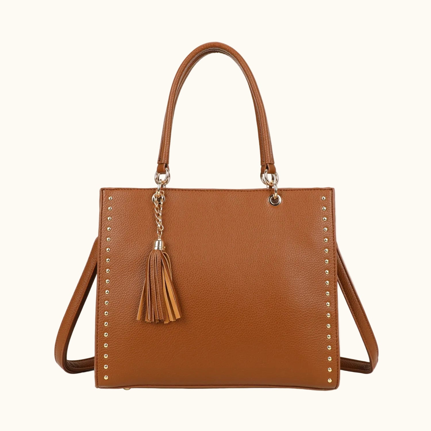 Brown handbag with tassel and stud details on a white background