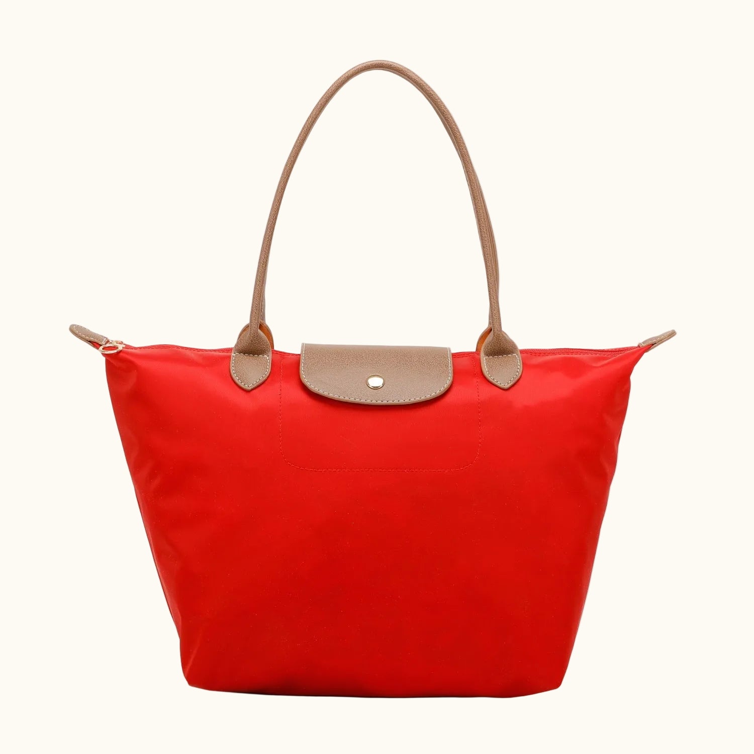 Red tote bag with brown handles and trim on a white background