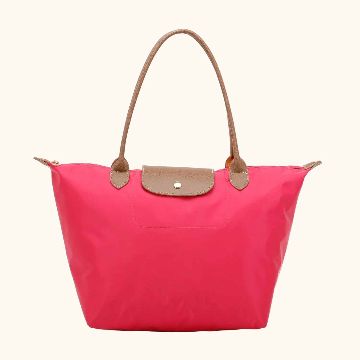 Pink tote bag with brown handles and trim on a white background