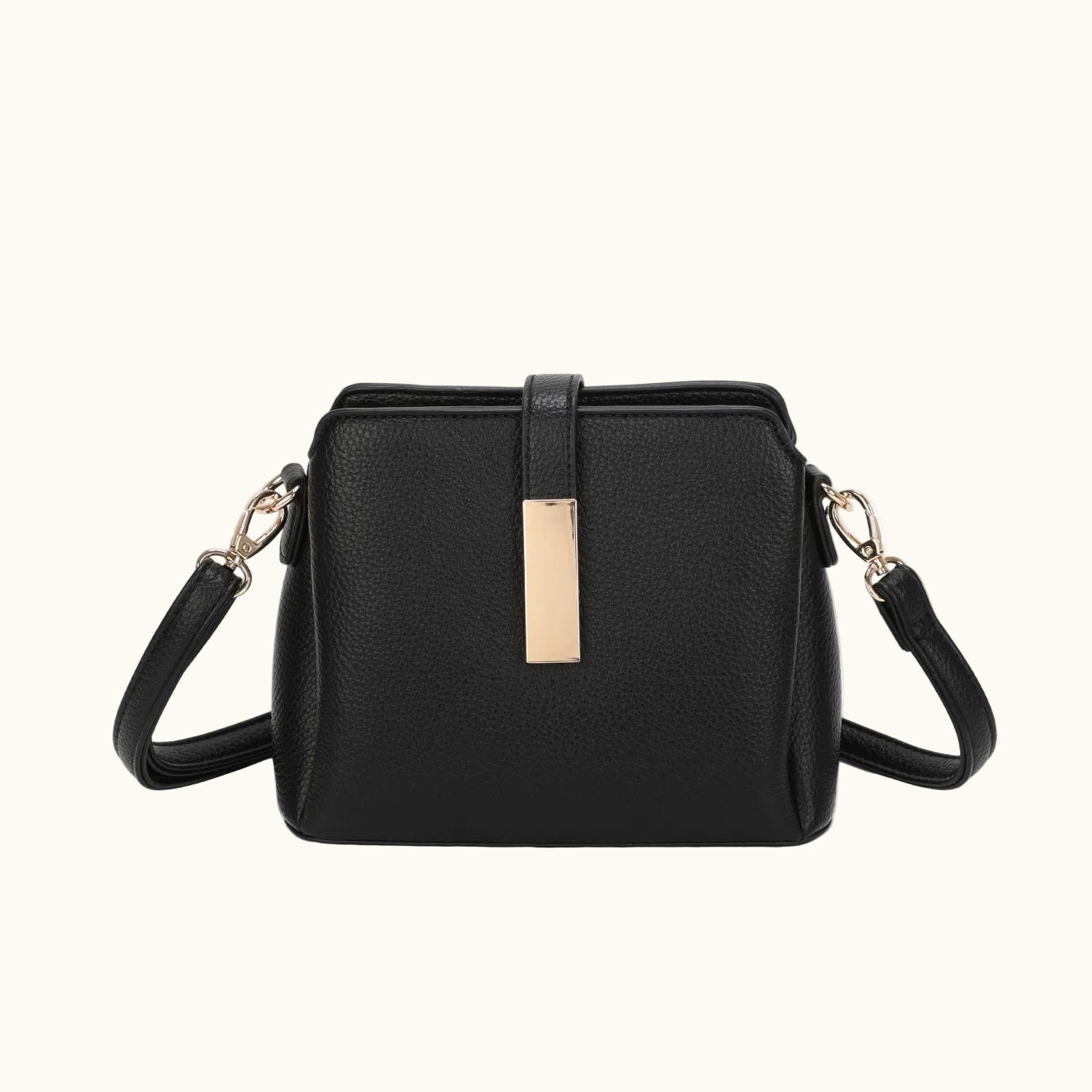 Black handbag with gold accents on a white background