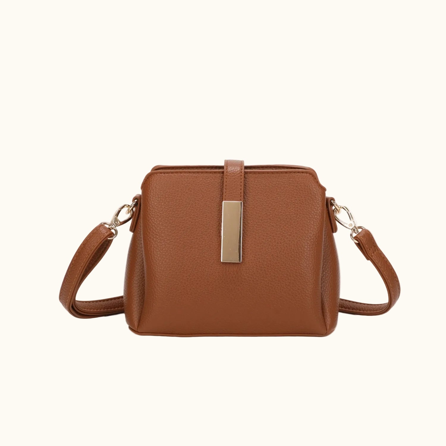 Brown leather handbag with a gold clasp on a white background