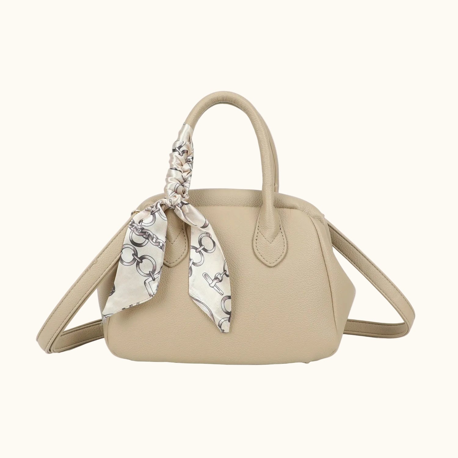 Beige handbag with a patterned scarf on a white background