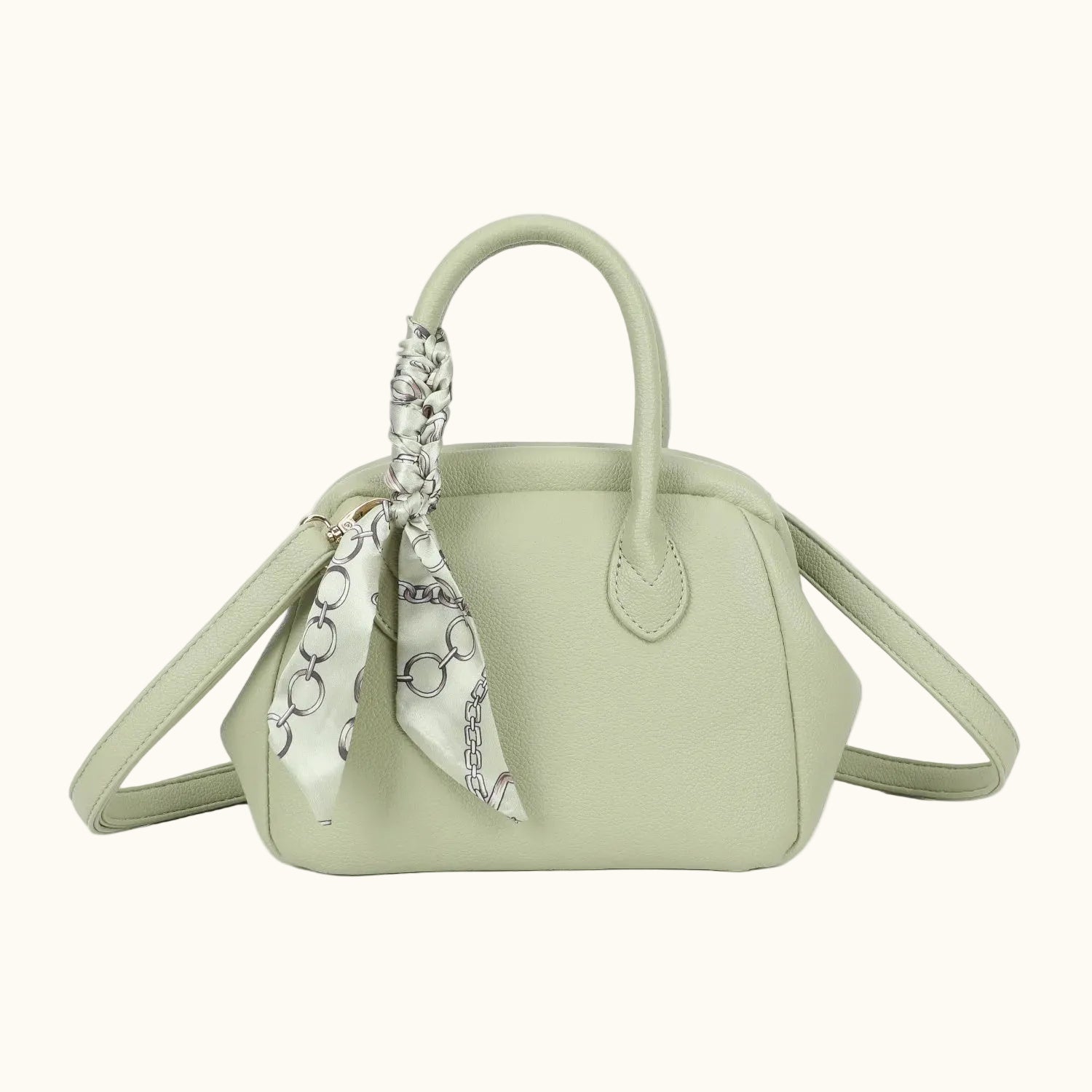 Light green handbag with a decorative scarf on a white background