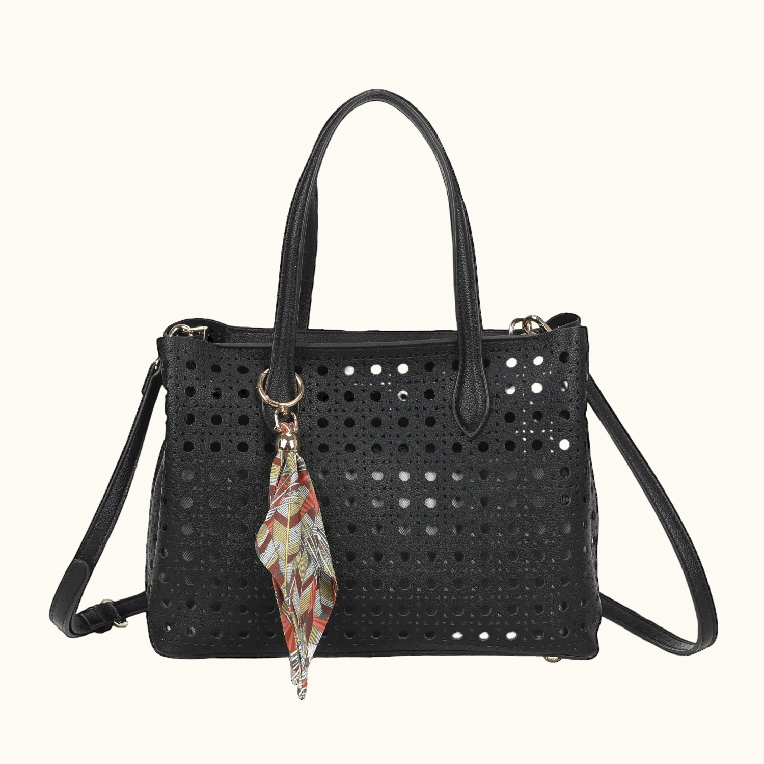 Black perforated handbag with a colorful keychain on a white background