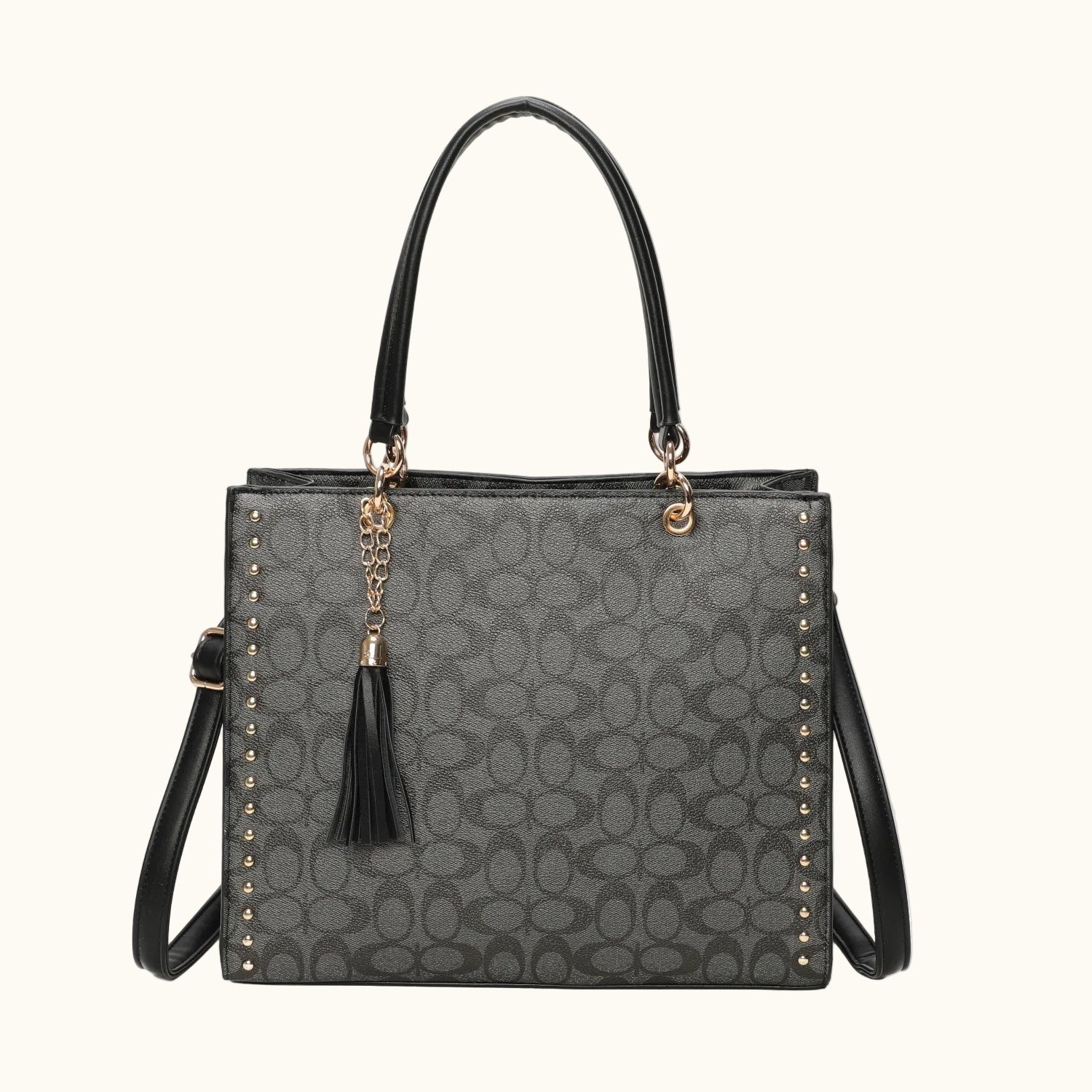 Gray handbag with black accents and tassel on a white background