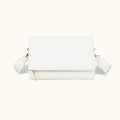 White handbag with gold accents on a white background