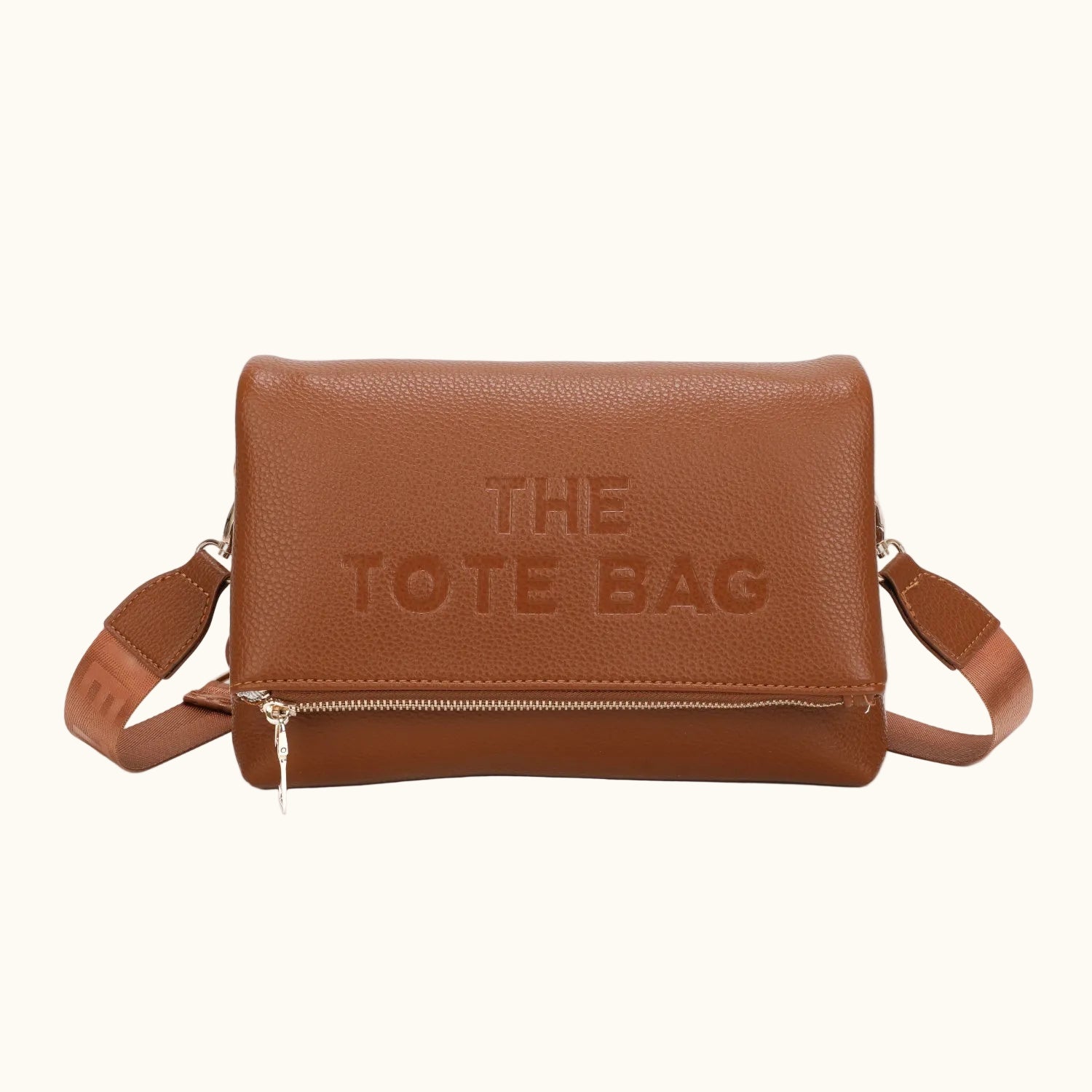 Brown tote bag with 'THE TOTE BAG' embossed on it on a white background