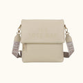 Beige crossbody bag with 'The Note Bag' branding on a white background