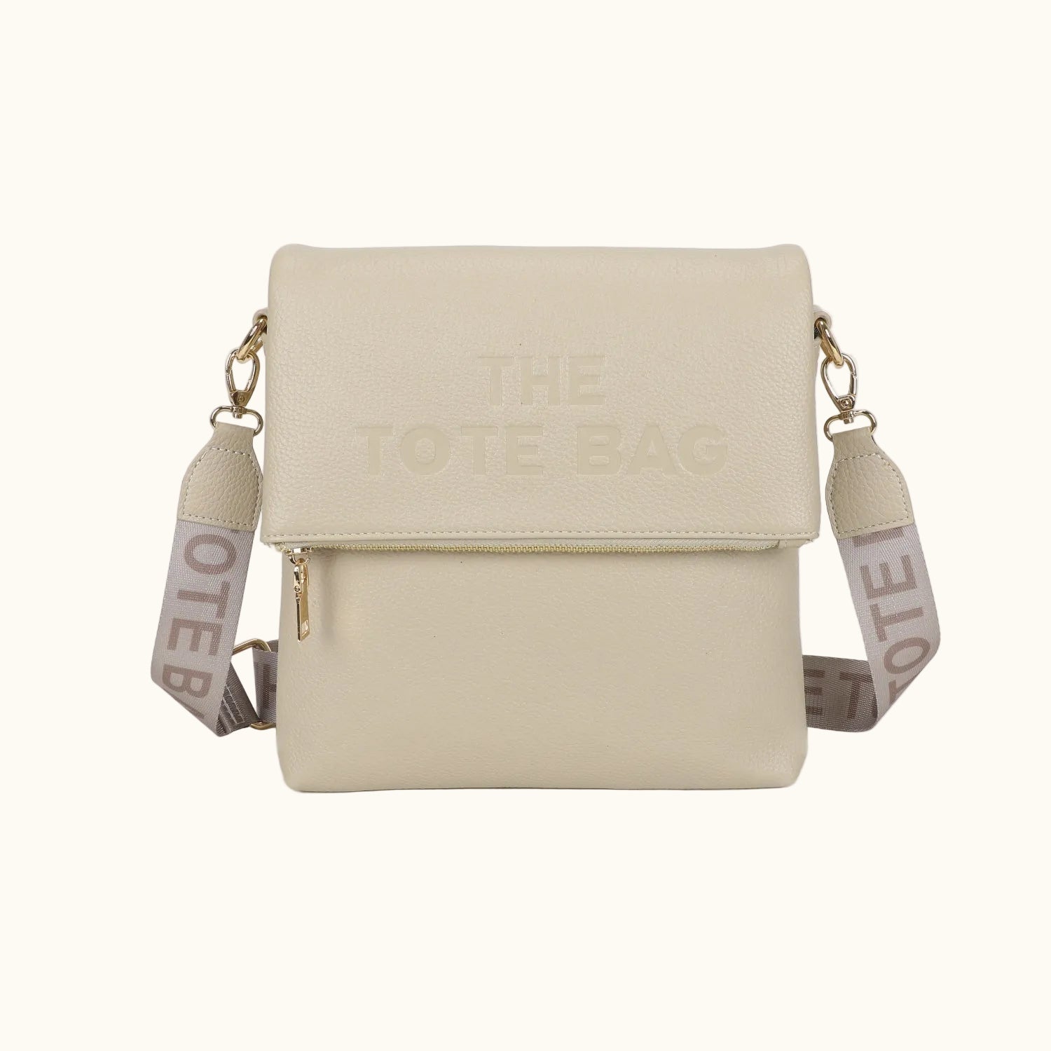 Beige crossbody bag with 'The Note Bag' branding on a white background