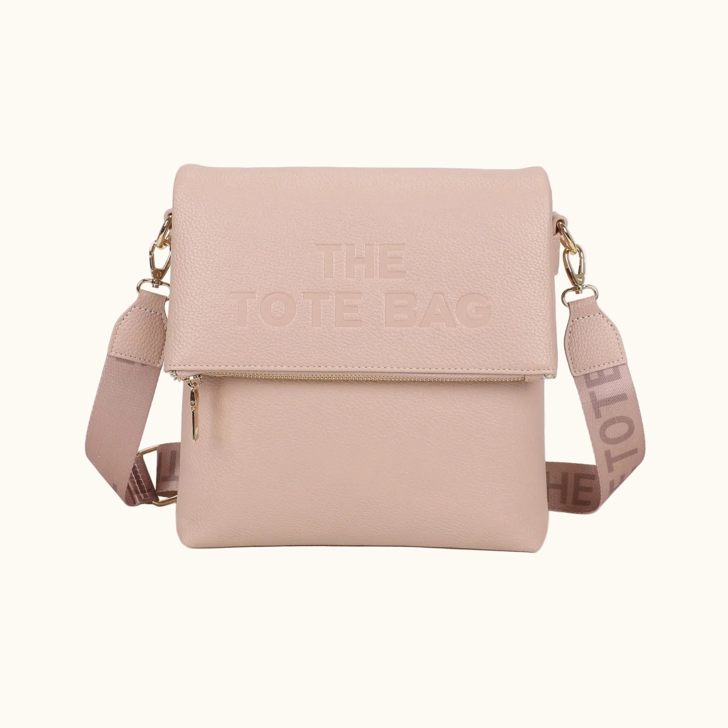 Beige crossbody bag with 'The Tote Bag' branding on a white background
