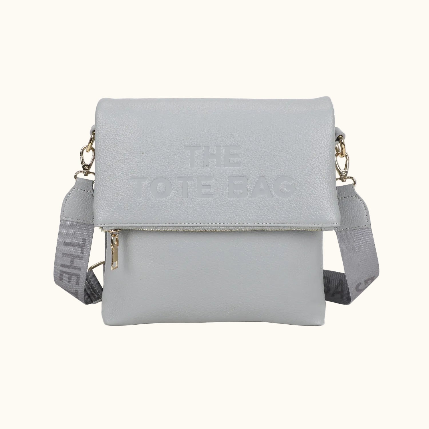 Gray tote bag with 'The Tote Bag' branding on a white background