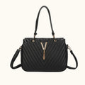 Black handbag with a gold zipper on a white background