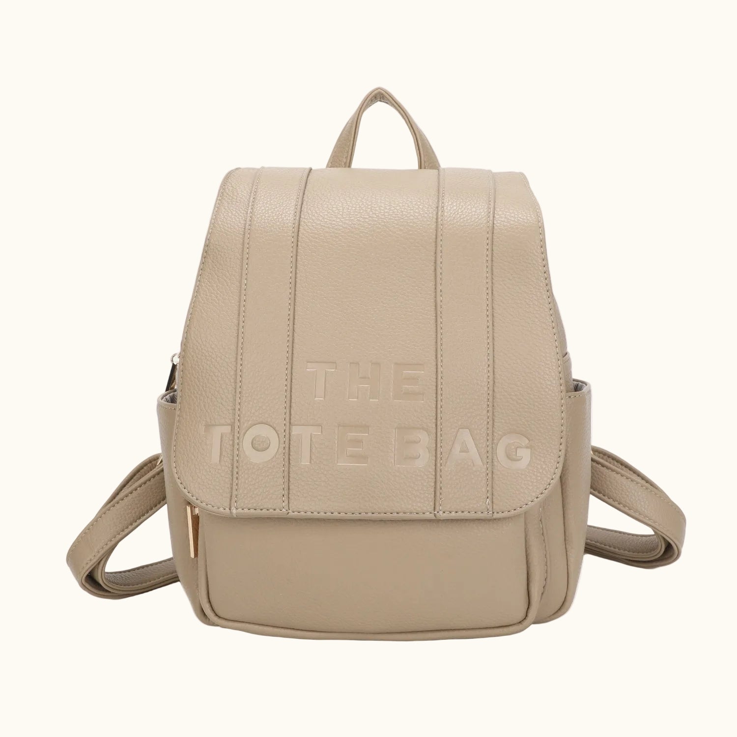 Beige backpack with 'THE TOTE BAG' text on a white background