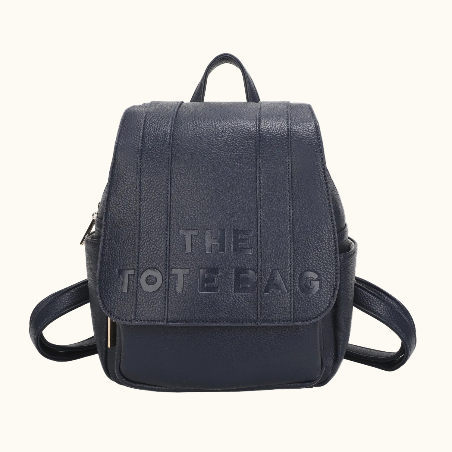 Navy blue backpack with 'THE TOTE BAG' text on a white background