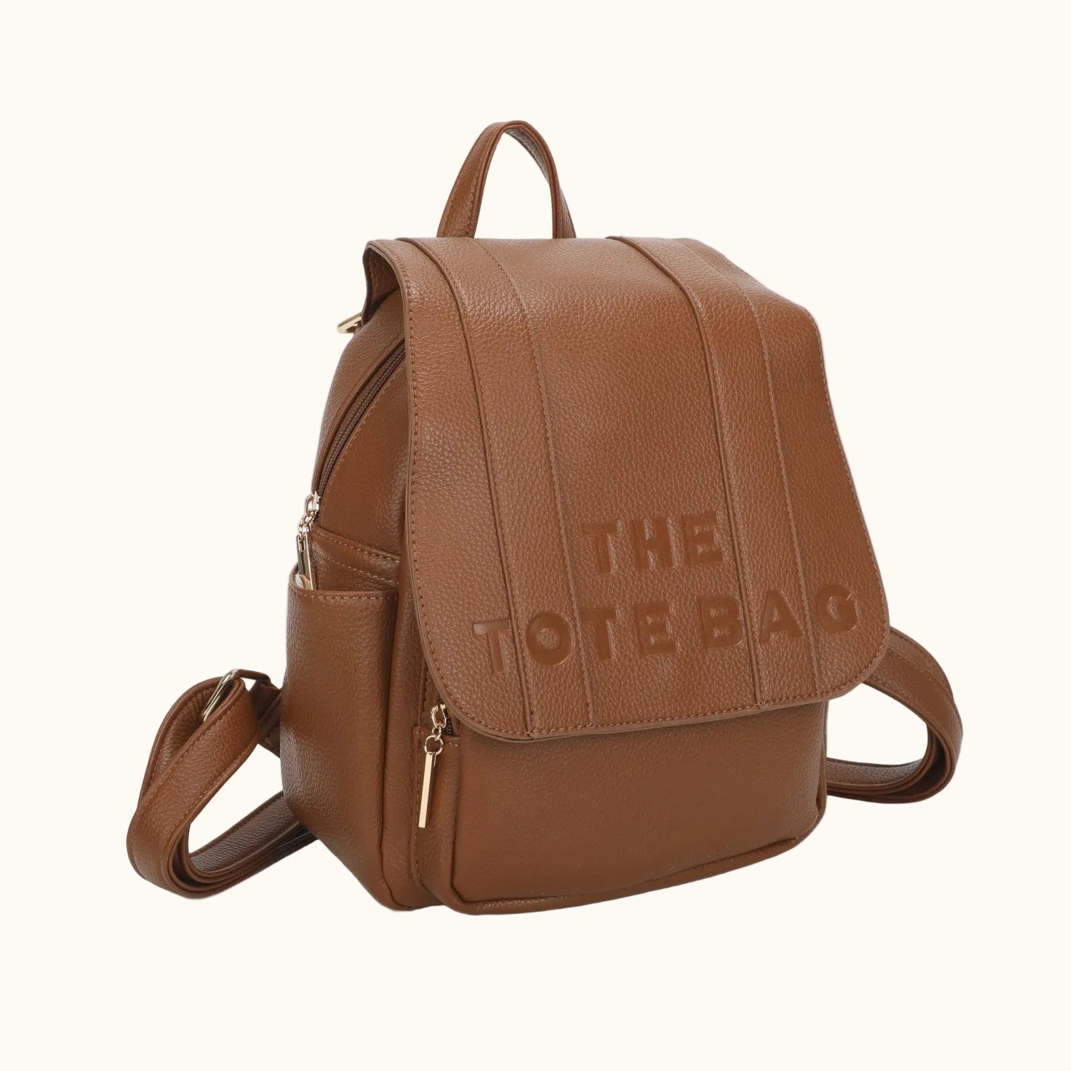 Brown leather backpack with 'THE TOTE BAG' text on a white background