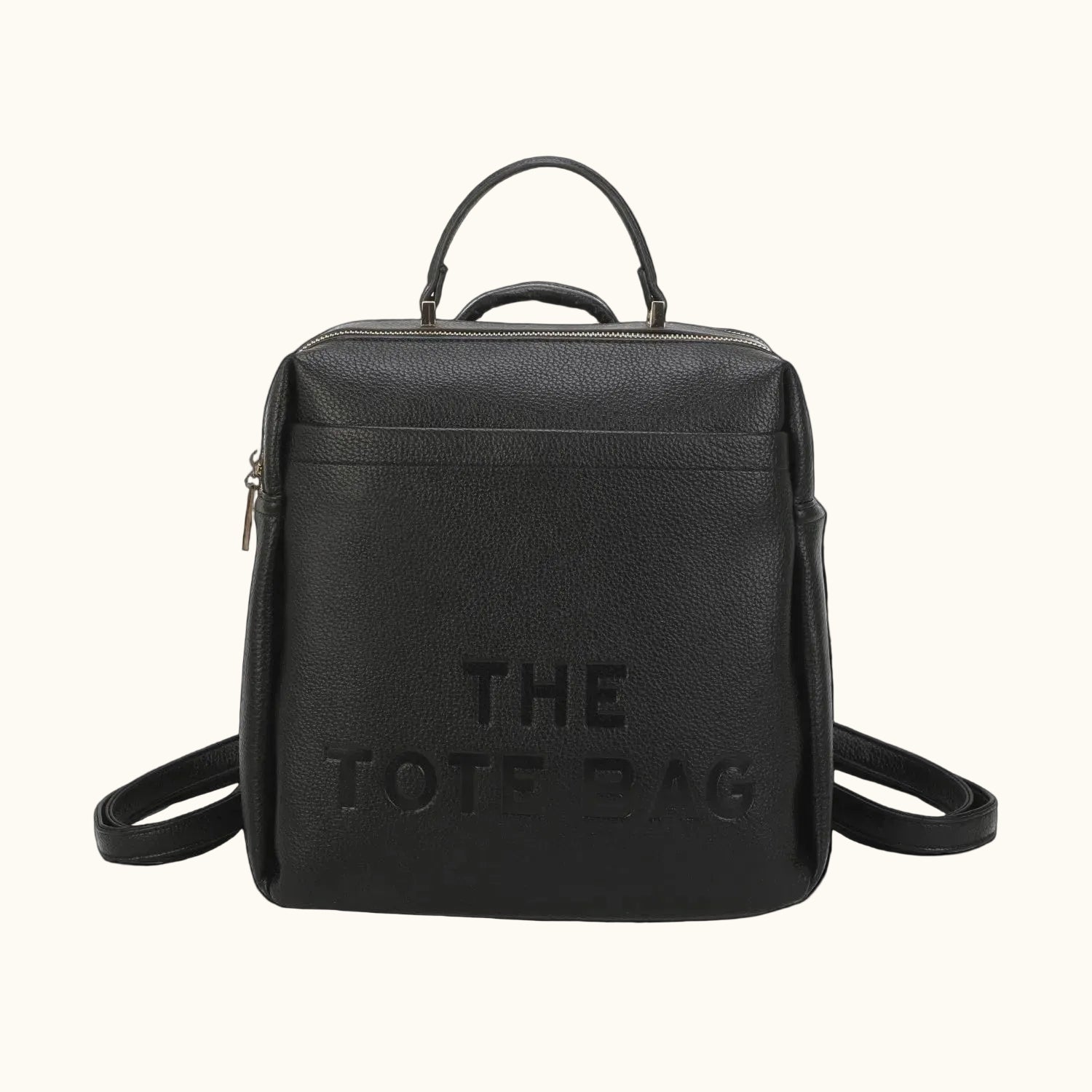 Black backpack with 'THE TOTE BAG' text on a white background