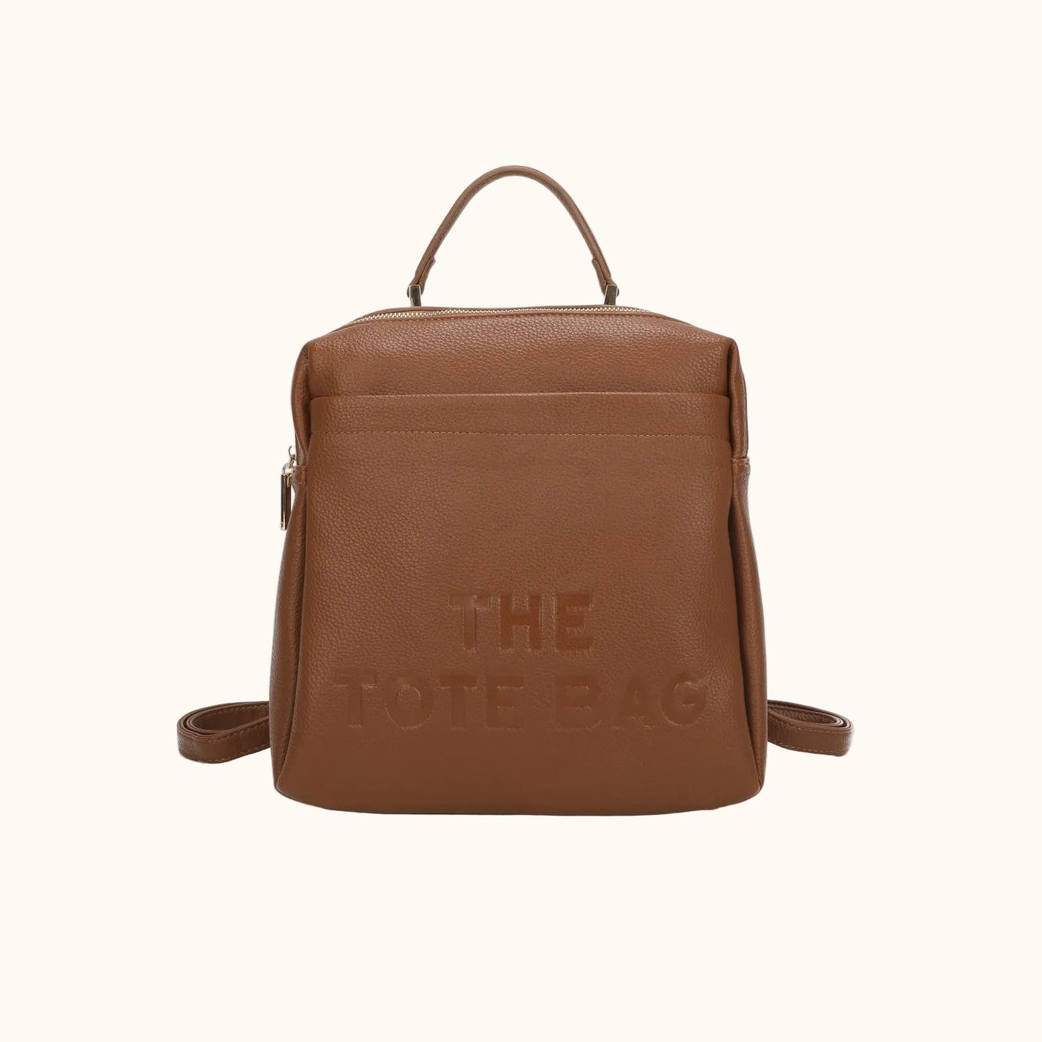 Brown leather backpack with 'THE TOTE BAG' text on a white background