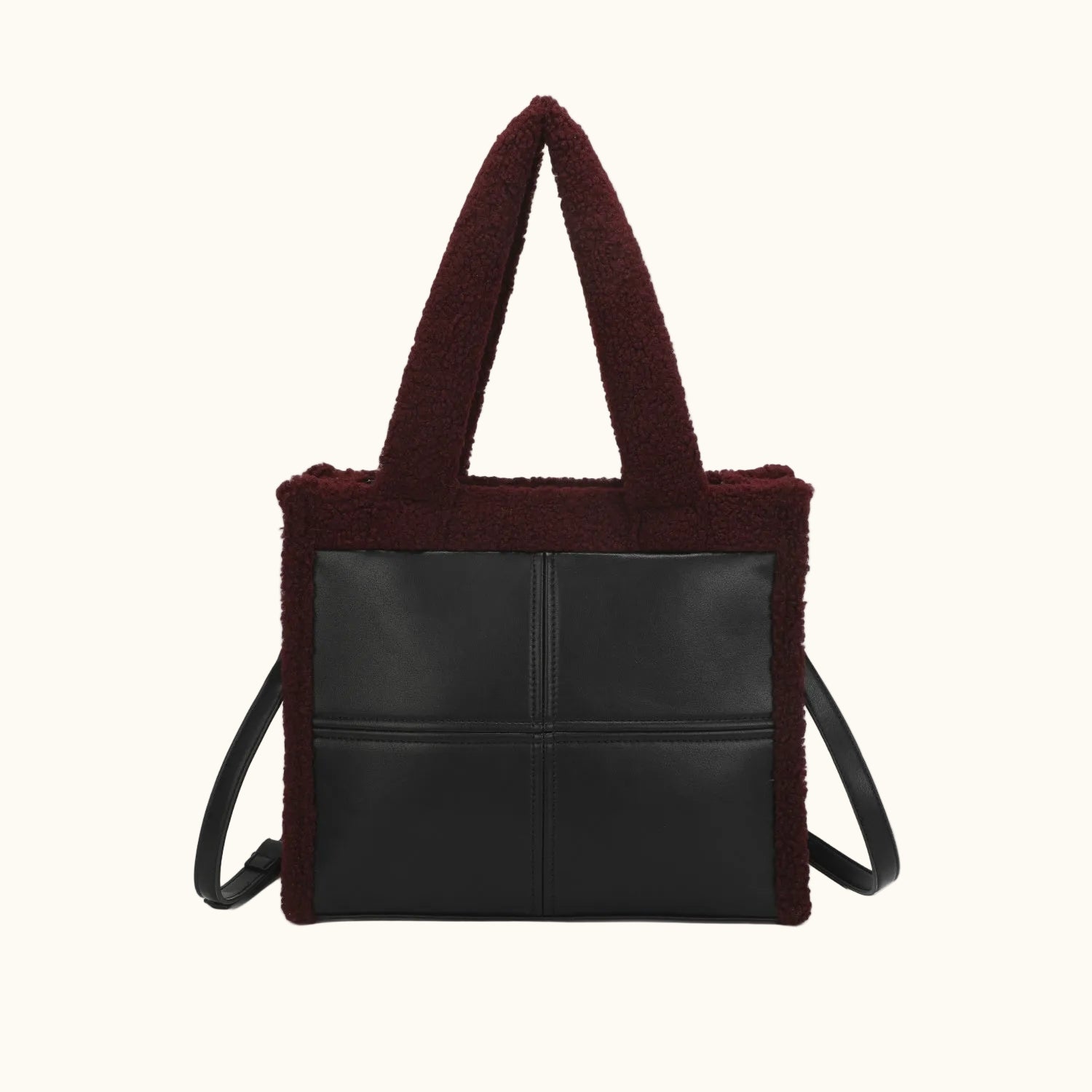 Black tote bag with burgundy shearling trim on a white background