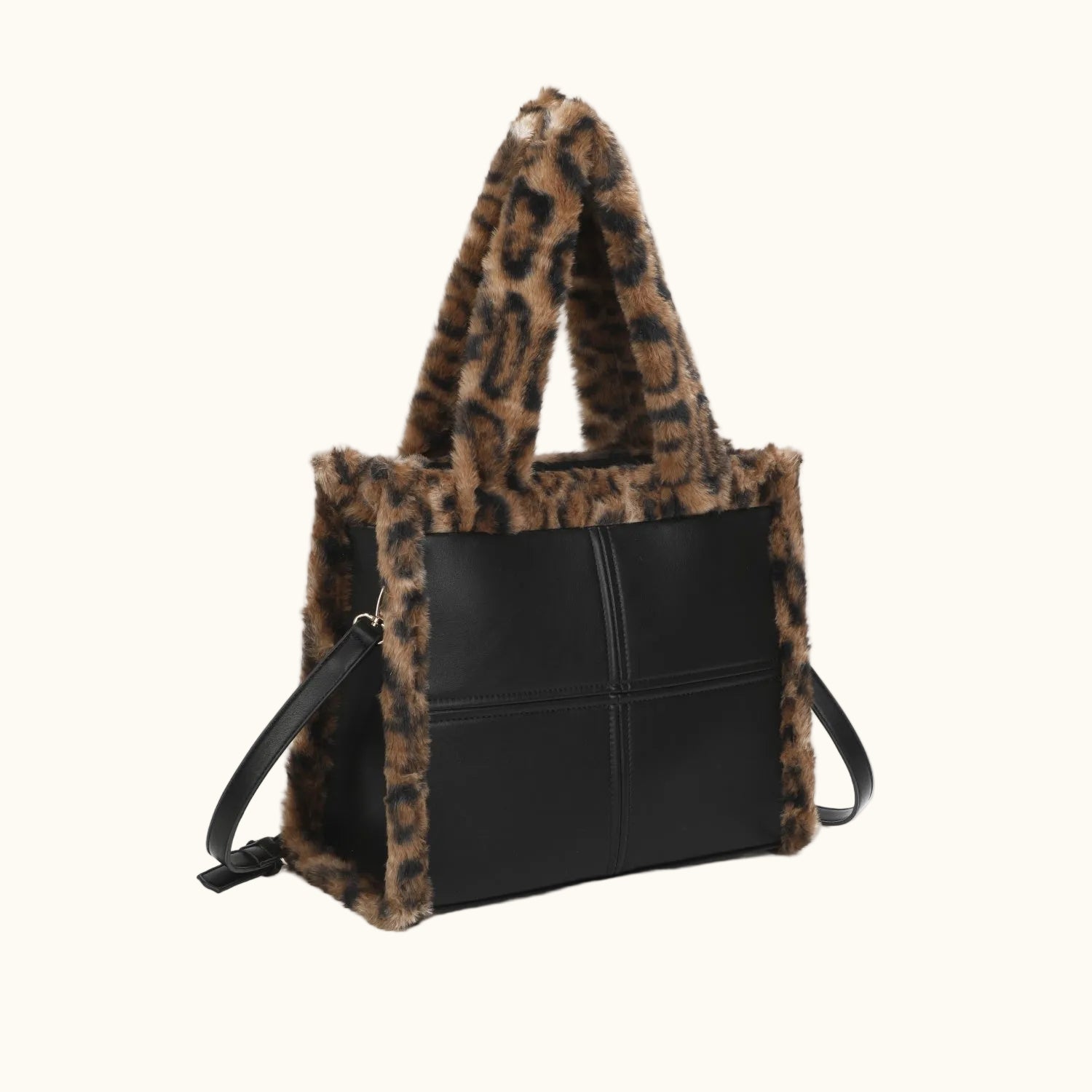 Black handbag with leopard print fur trim on a white background