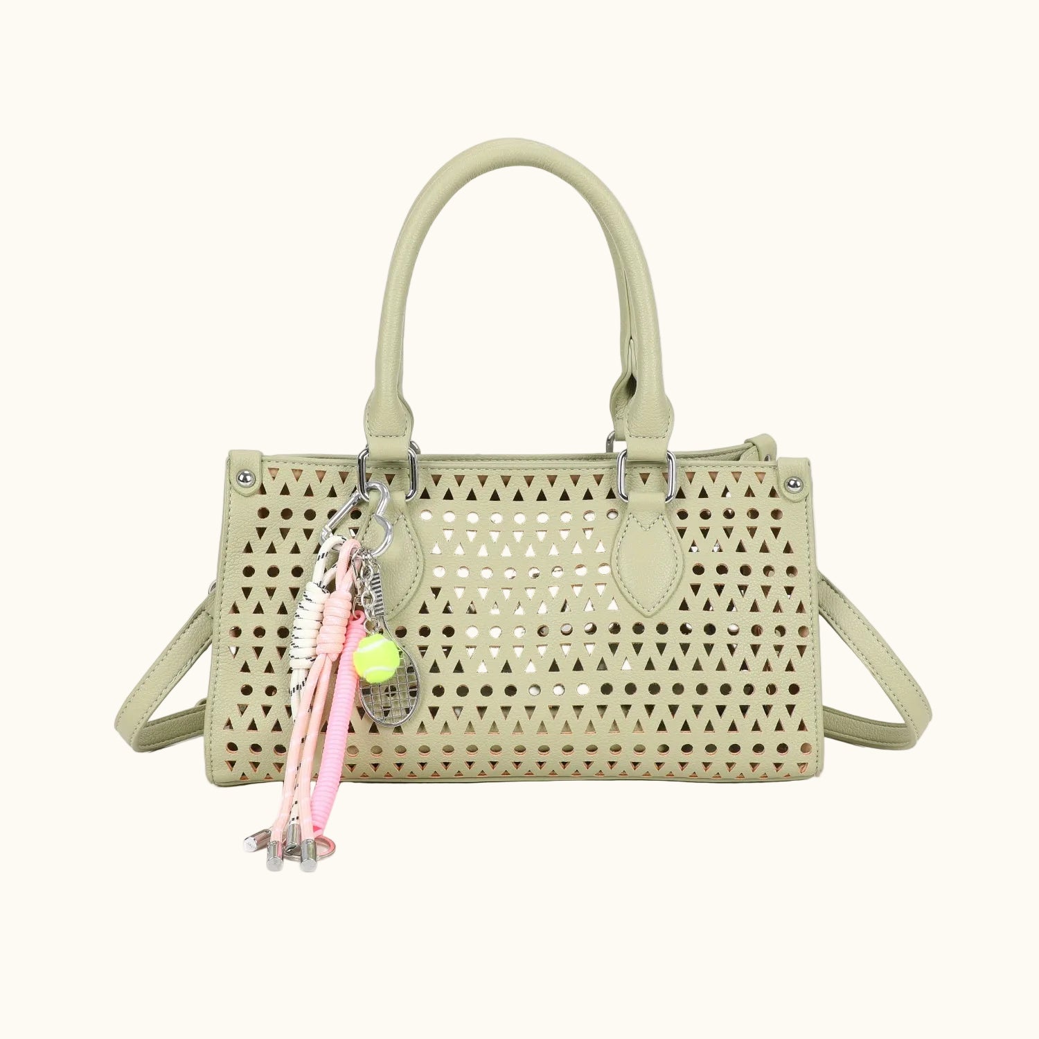 Beige handbag with decorative charms on a white background