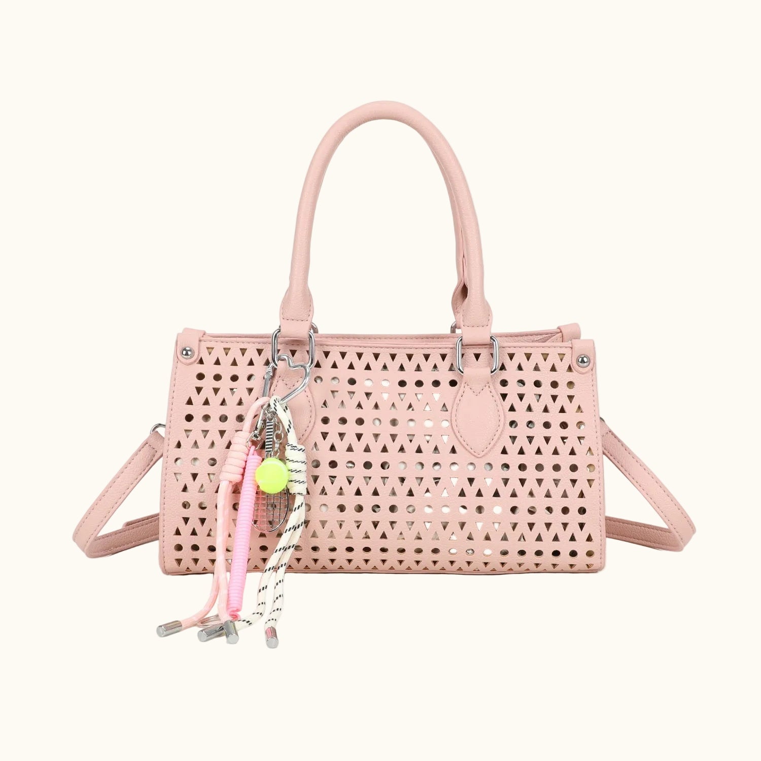 Pink handbag with decorative charms on a white background