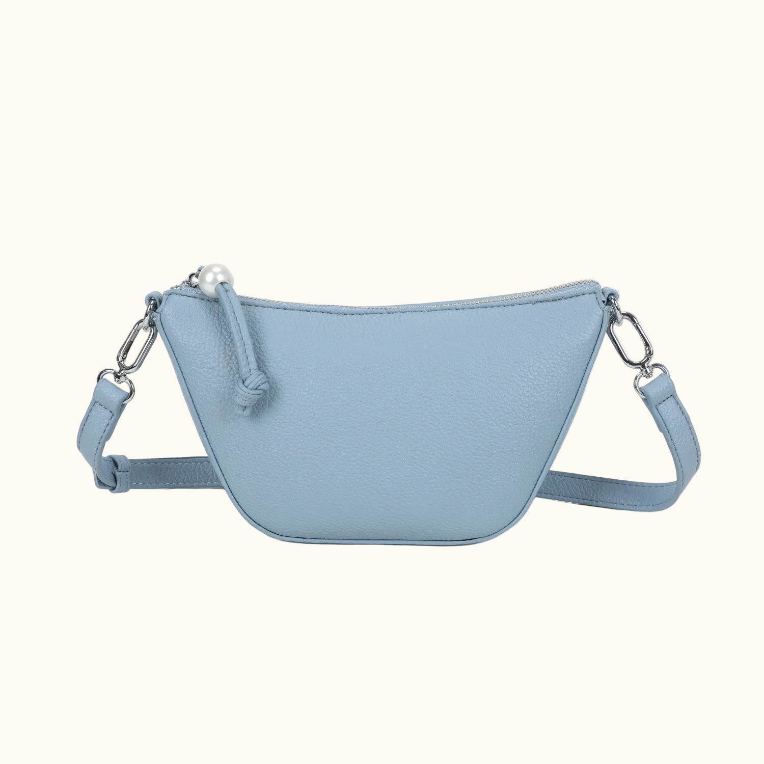 Light blue crossbody bag with a strap on a white background
