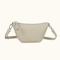 Beige crossbody bag with chain detail on a white background