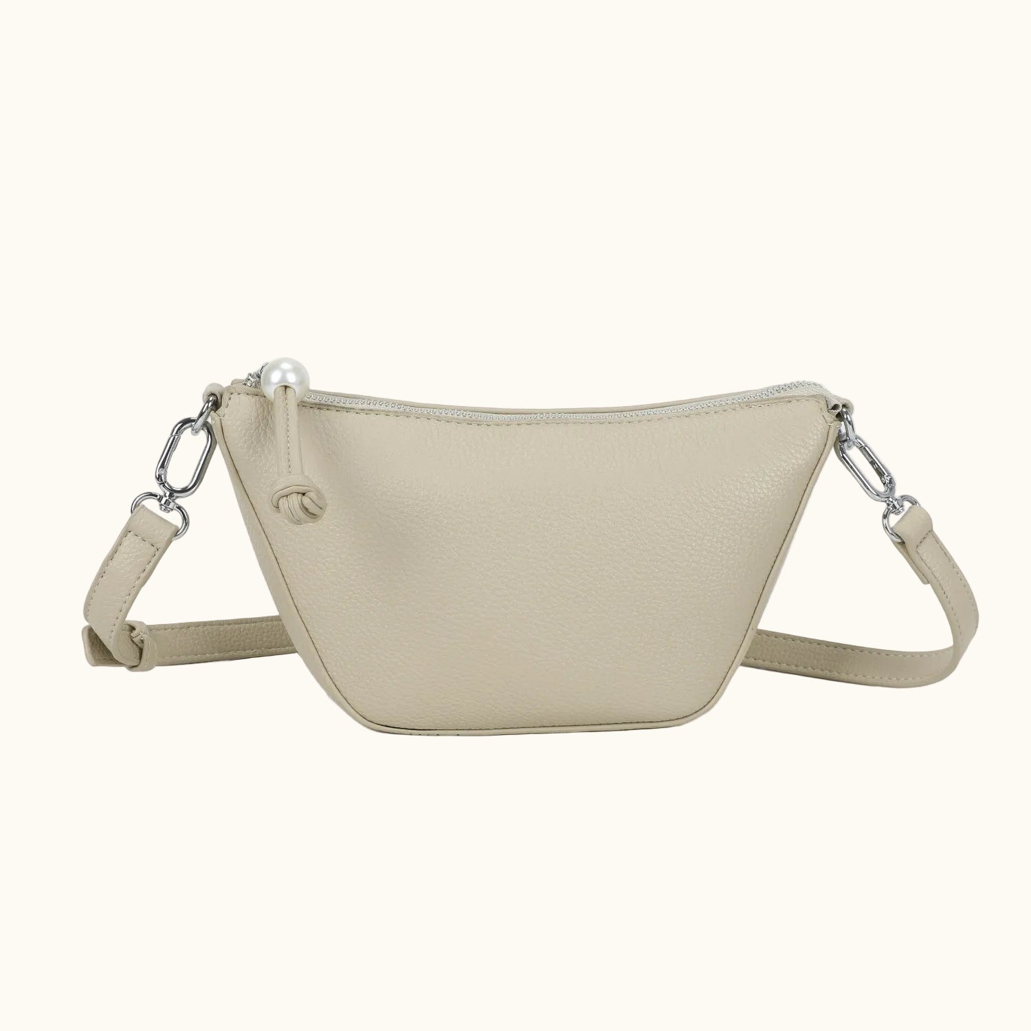 Beige crossbody bag with chain detail on a white background