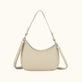 Beige handbag with a shoulder strap on a white background