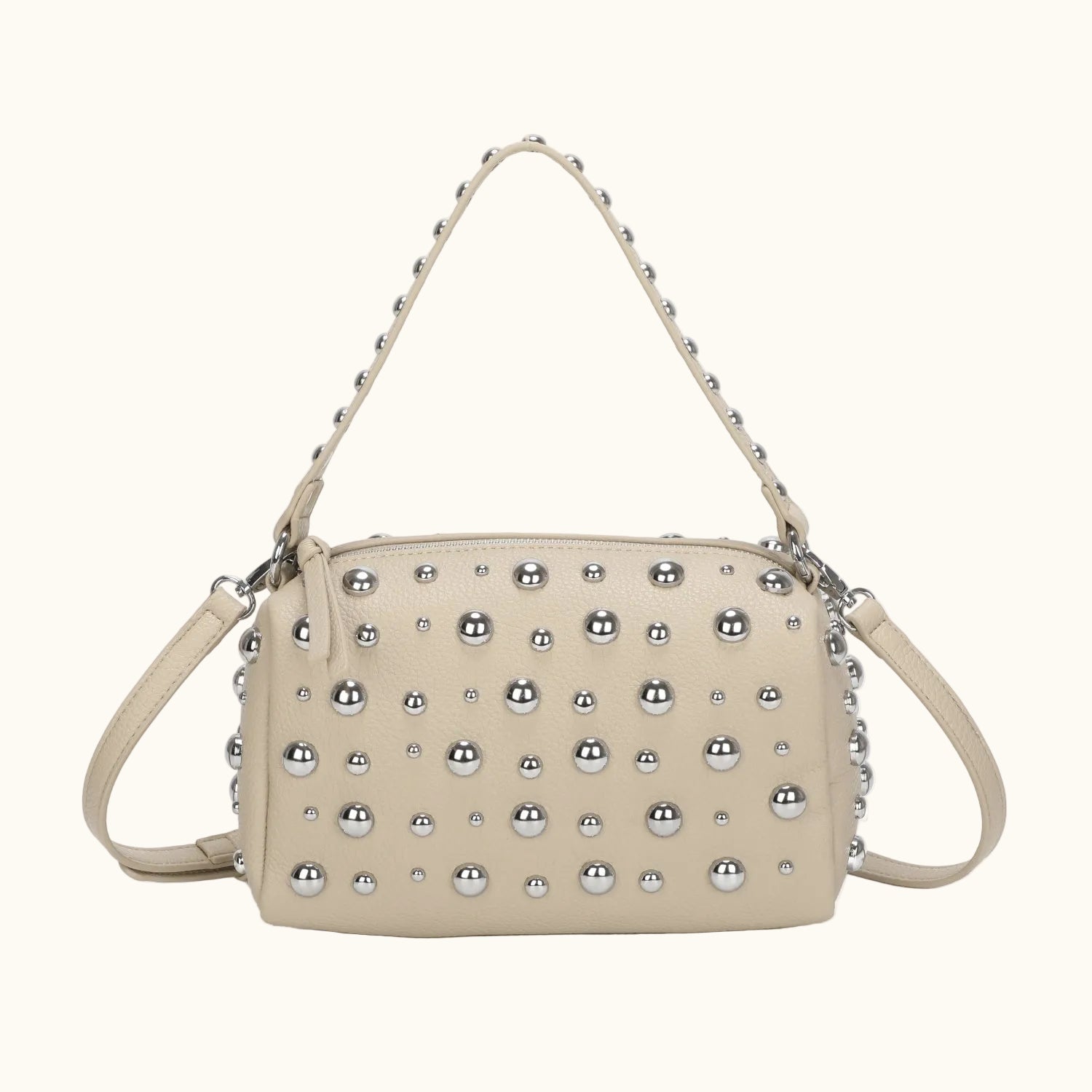 Beige handbag with silver studs on a white background