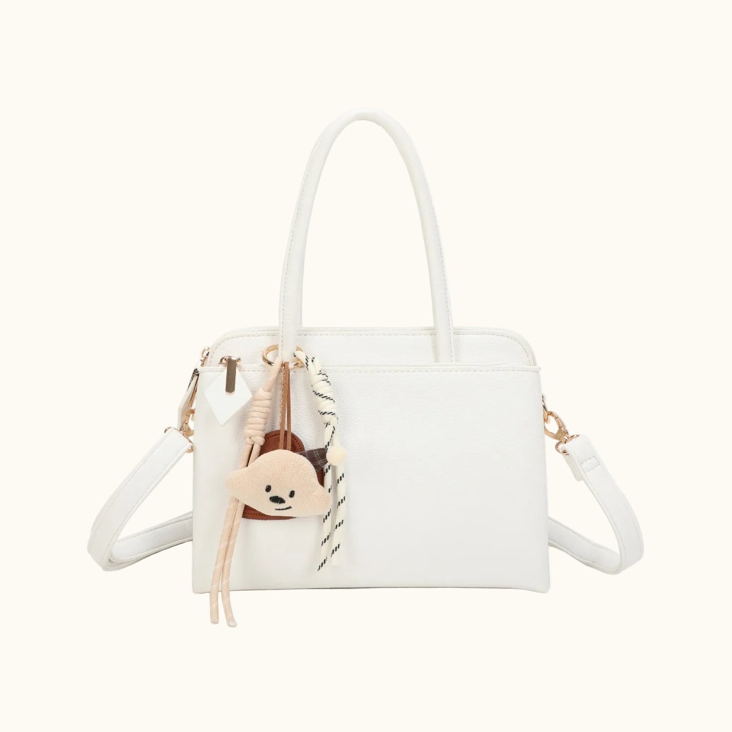 White handbag with a strap and decorative elements on a white background