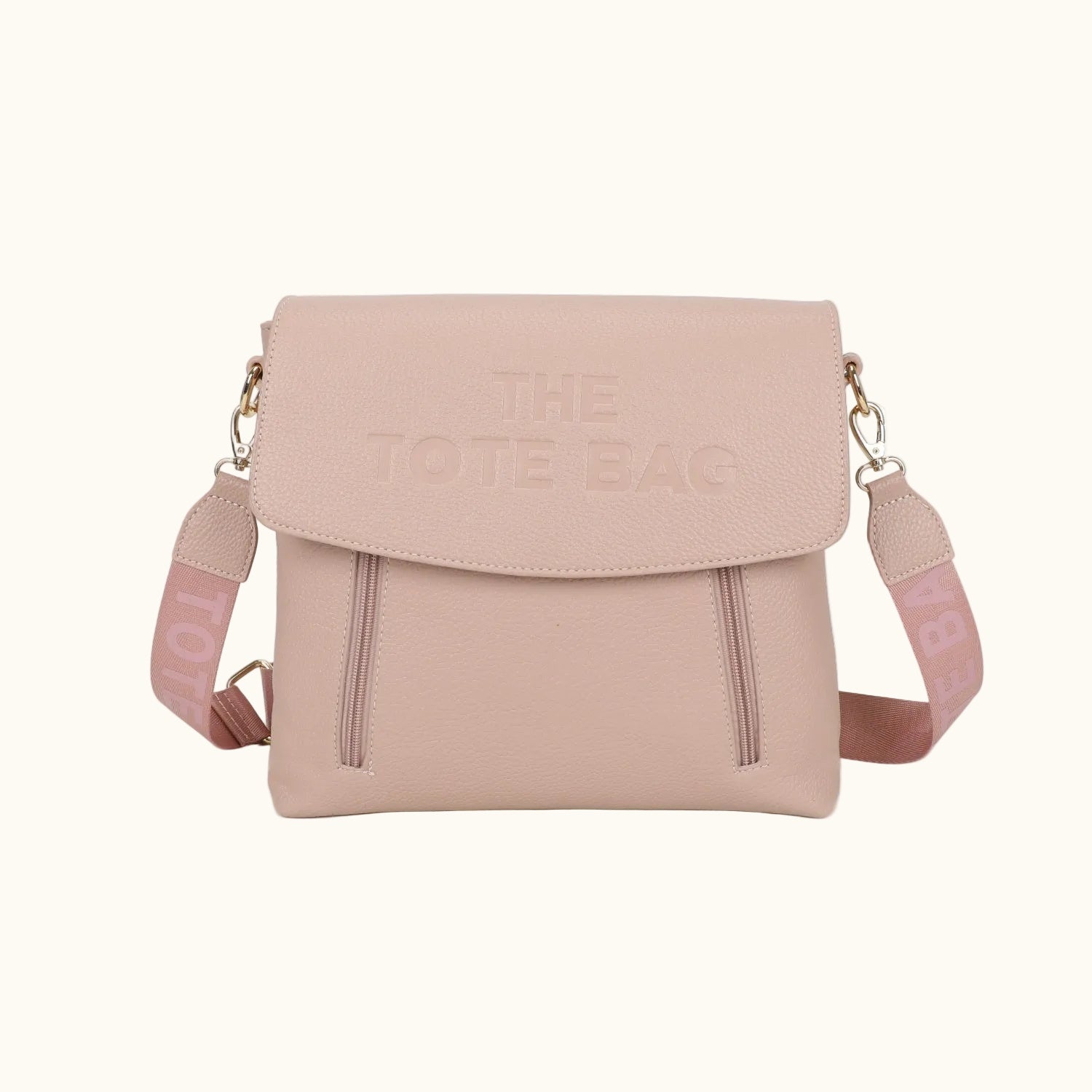 Pink crossbody bag with 'The Tote Bag' branding on a white background
