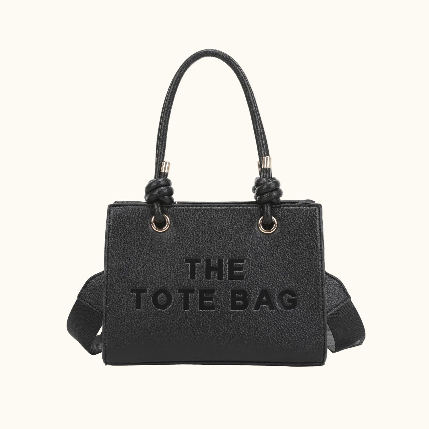 Black tote bag with 'THE TOTE BAG' text on a white background