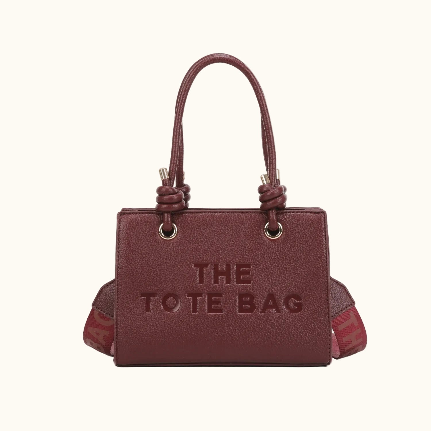 Brown tote bag with 'THE TOTE BAG' text on a white background