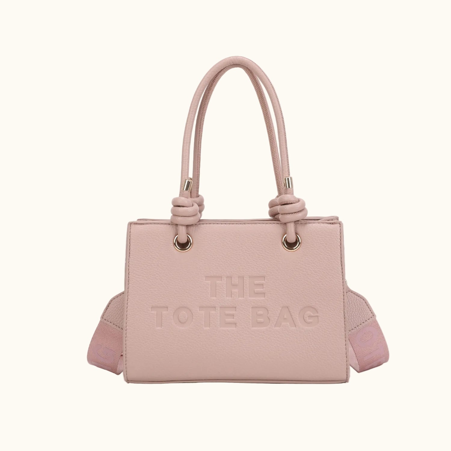 Pink tote bag with 'THE TOTE BAG' text on a white background
