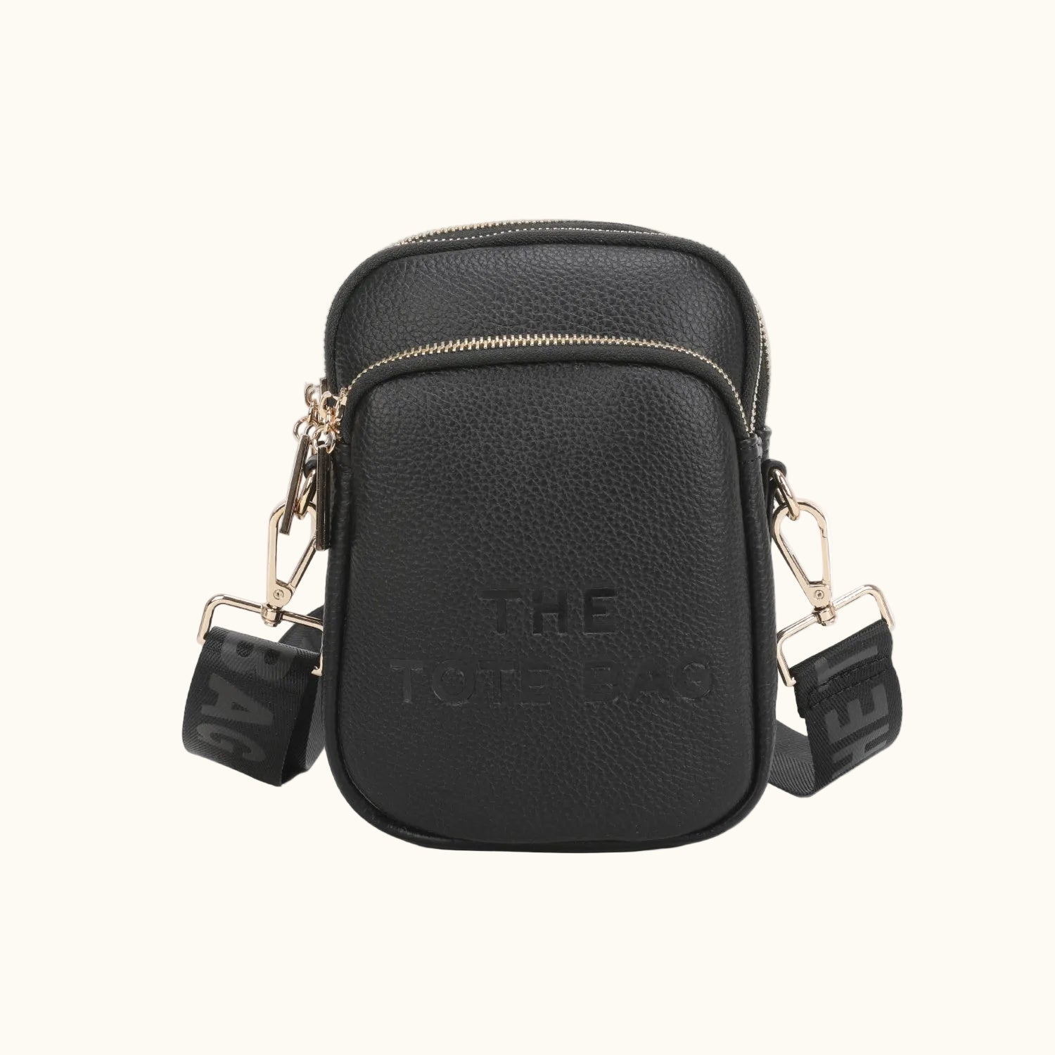 Black crossbody bag with gold accents on a white background