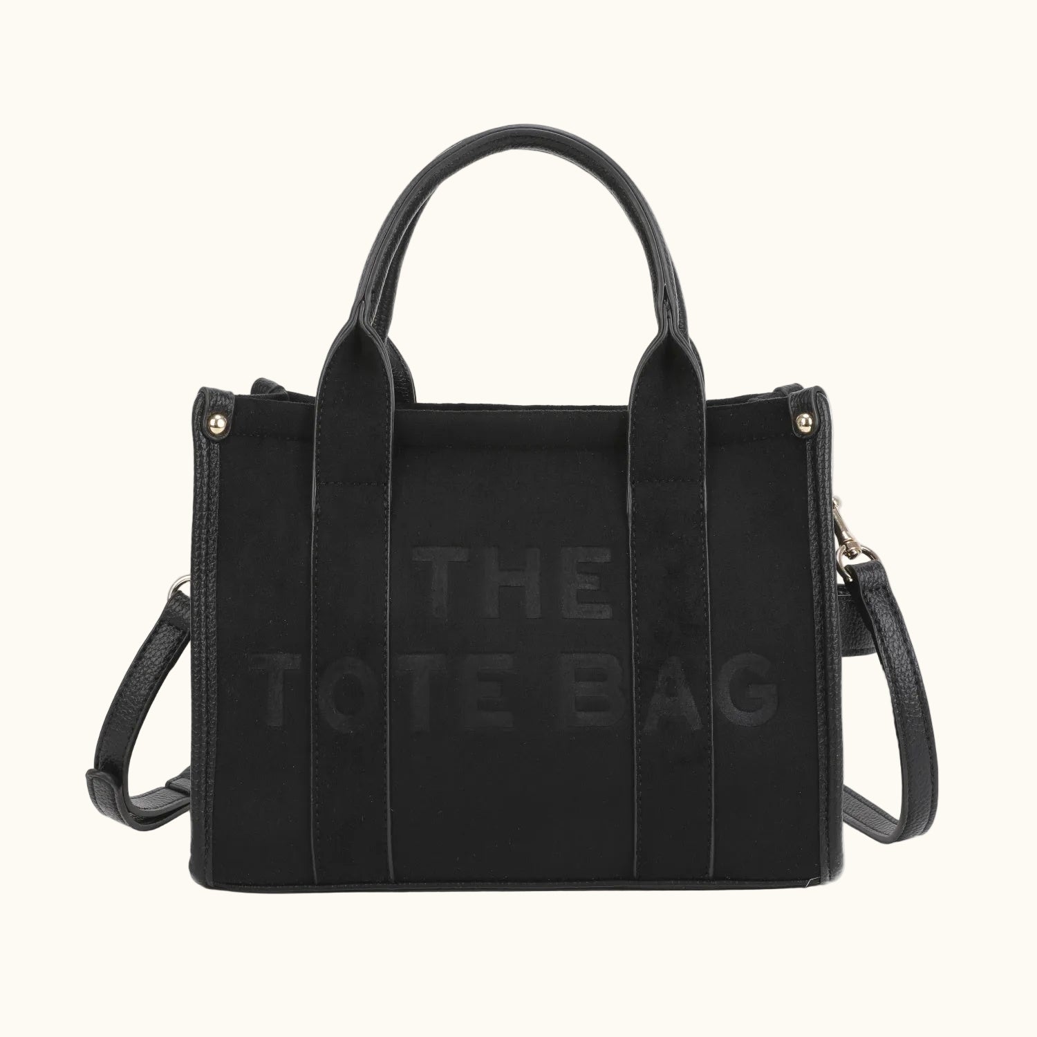 Black tote bag with 'The Tote Bag' branding on a white background