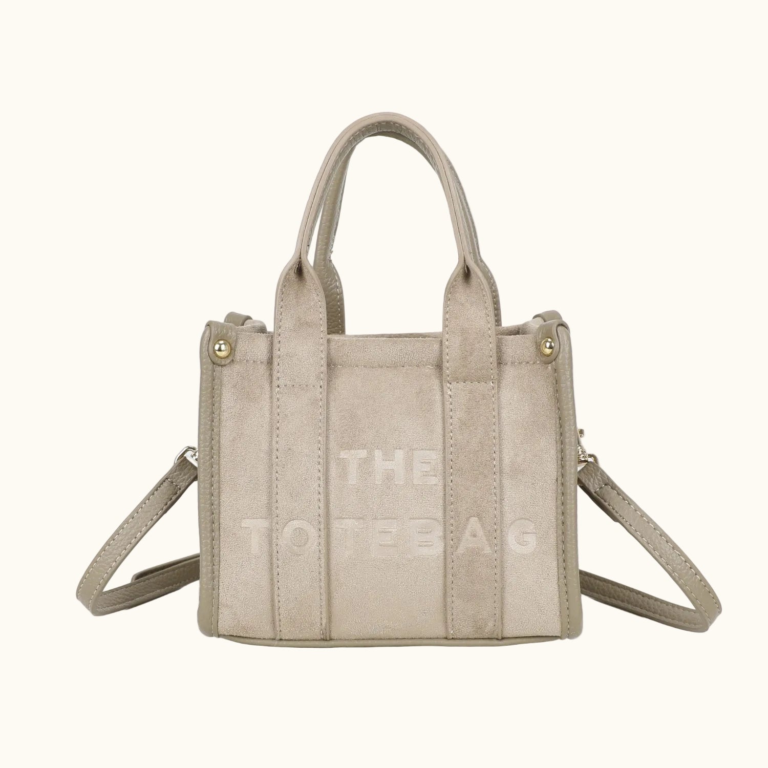 Beige handbag with 'THE TOTE BAG' text on a white background