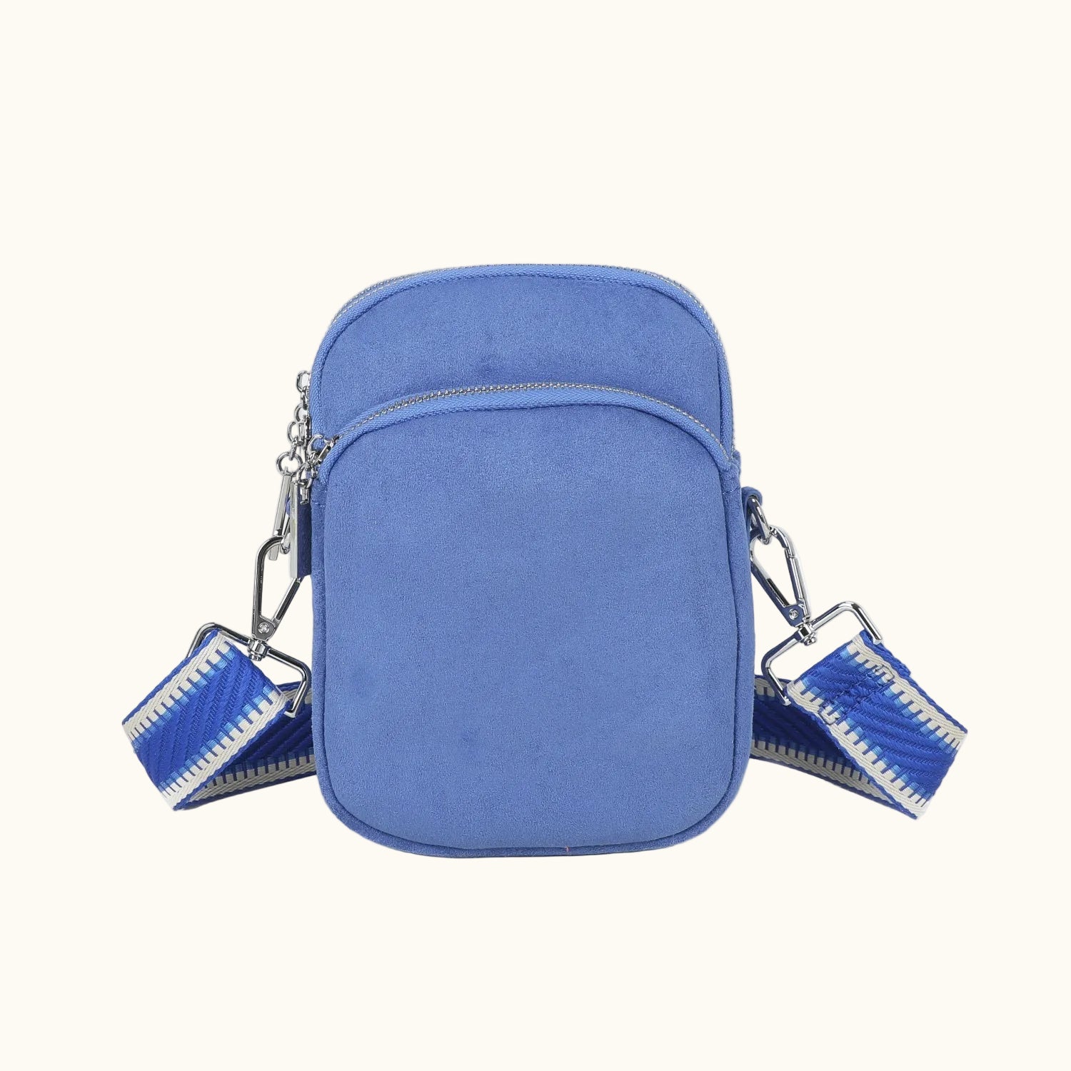 Blue crossbody bag with zippers on a white background