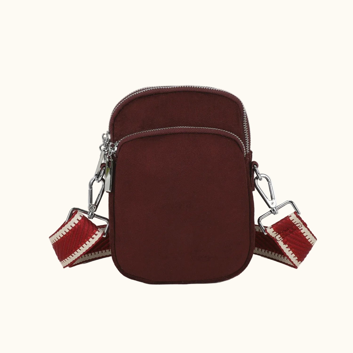 Brown crossbody bag with red strap on a white background
