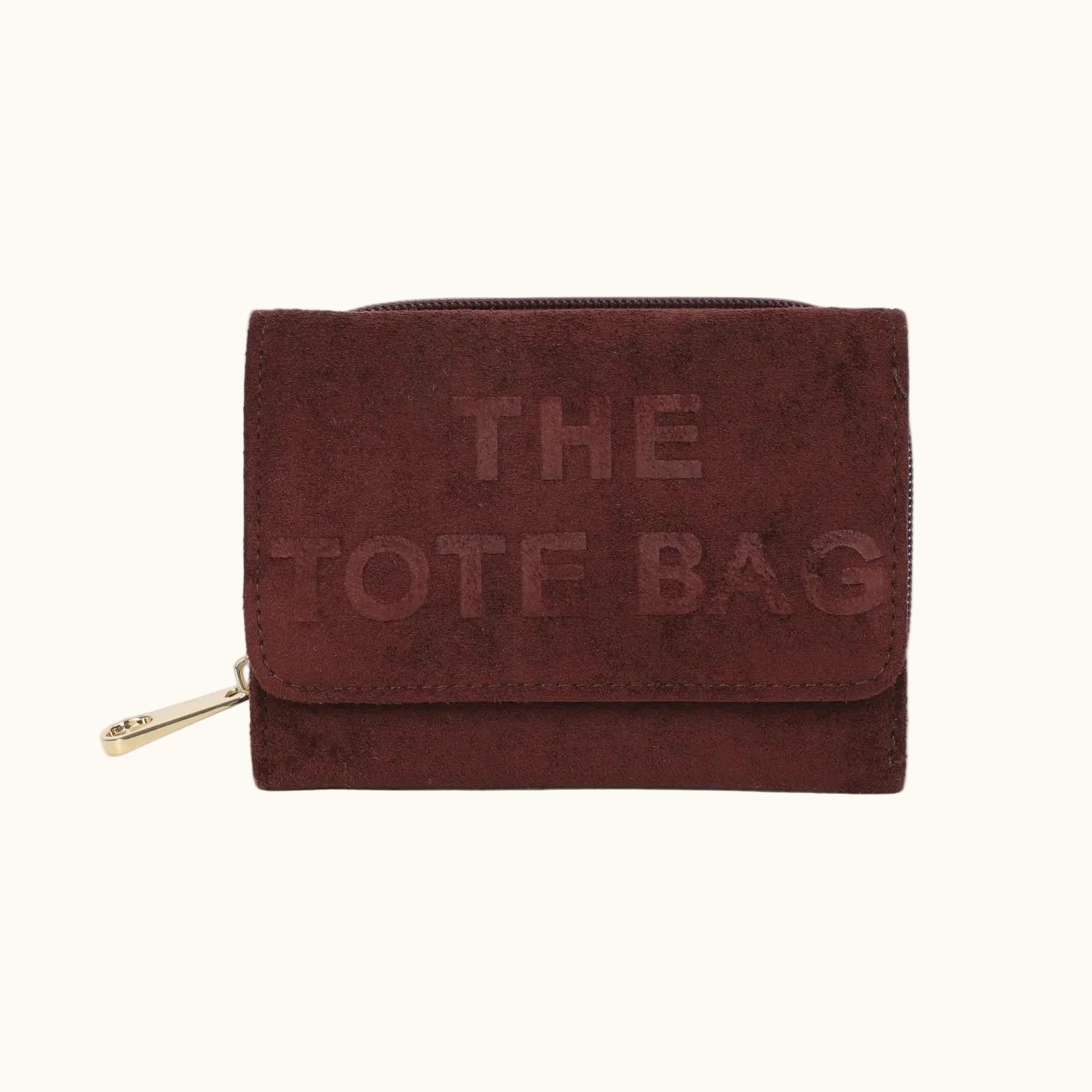 Brown suede tote bag with 'THE TOTE BAG' embossed text on a white background